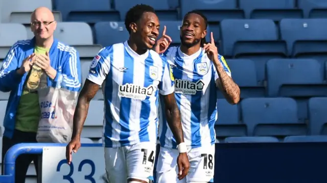 David Kasumu celebrates sealing the points for Huddersfield against Barnsley