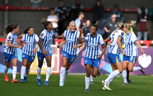 Brighton players run back to kick off after one of their goals