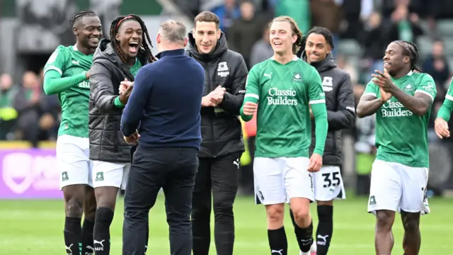 Plymouth Argyle manager Wayne Rooney comes out on to the pitch to celebrate the win with his players at full time