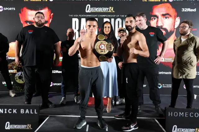 Nick Ball holds the WBA featherweight title and stands next to Ronny Rios