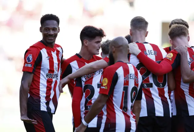 Brentford's Ethan Pinnock celebrates scoring their fourth goal with teammates