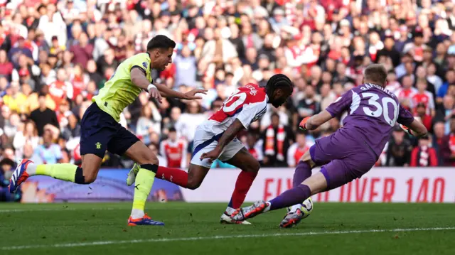 rsenal's Raheem Sterling (centre) appears to go to the ground after pressure from Southampton goalkeeper Aaron Ramsdale (right) during the Premier League match at the Emirates Stadium, London.