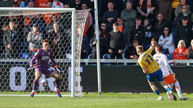 Mansfield's Will Evans scores the first of his two goals against Blackpool