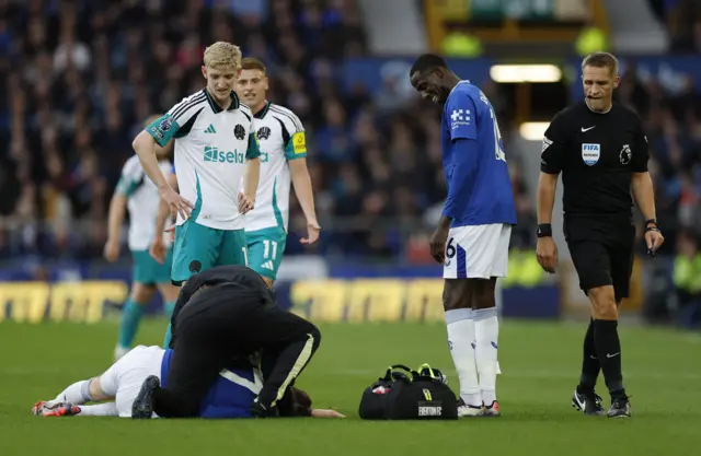 Everton's James Garner receives medical attention after sustaining an injury