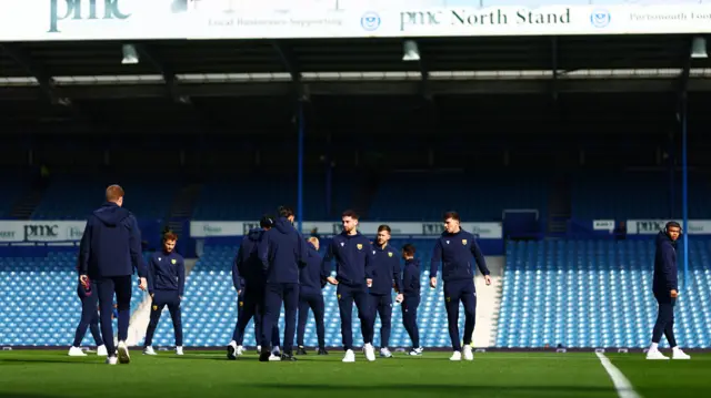 Oxford players warm up at Fratton Park