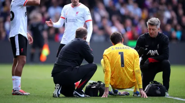 Alisson Becker of Liverpool receives medical treatment during the Premier League match between Crystal Palace FC and Liverpool FC at Selhurst Park on October 05, 2024 in London, England.