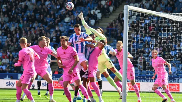 Gabriel Slonina punches a corner away for Barnsley