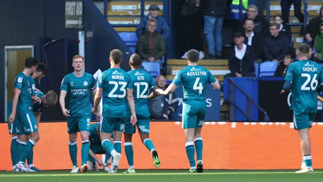 Shrewsbury players celebrate Josh Feeney's goal at Bolton