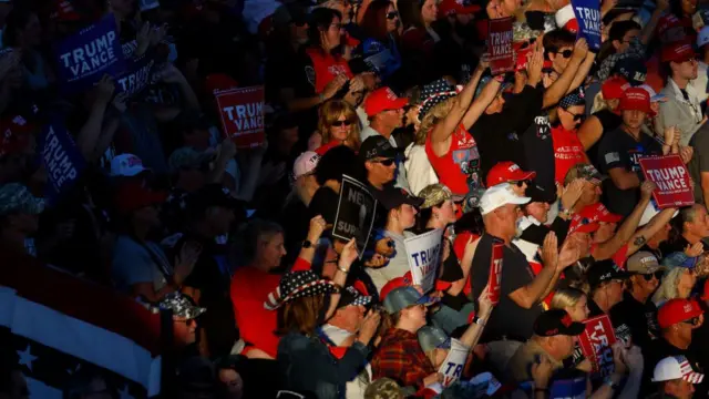 Supporters of Donald Trump watch him speak at a rally in Butler, Pennsylvania