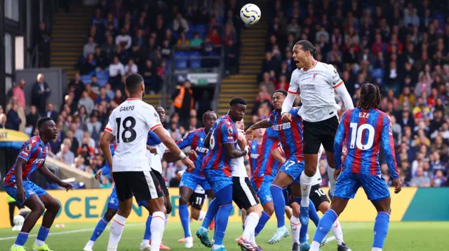 Liverpool's Virgil van Dijk heads at goal