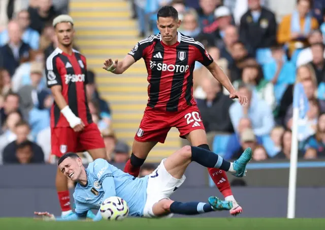 hil Foden (L) of Manchester City is fouled by Sasa Lukic of Fulham during the English Premier League soccer match between Manchester City and Fulham FC in Manchester, Britain, 05 October 2024.