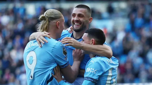 Manchester City's Mateo Kovacic celebrates scoring their second goal with Manchester City's Erling Haaland and Manchester City's Phil Foden