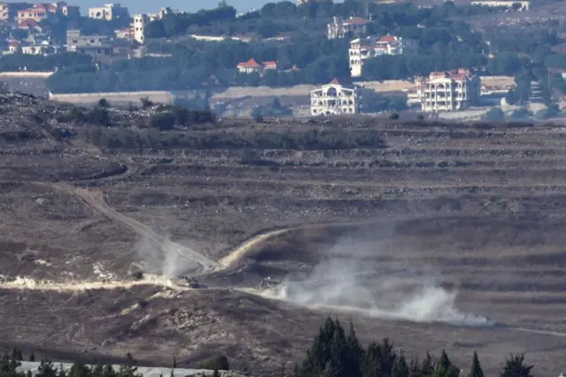 Israeli forces moving through southern Lebanon, as seen from Israel on Friday