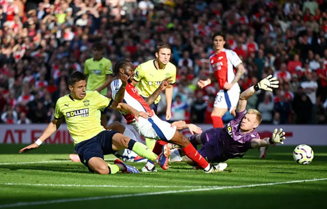 Raheem Sterling of Arsenal shoots under pressure from Jan Bednarek