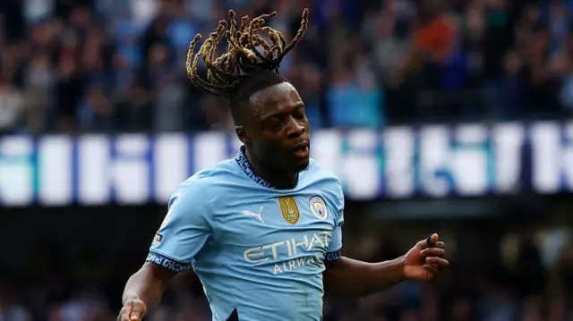 Manchester City's Jeremy Doku celebrates scoring their third goal