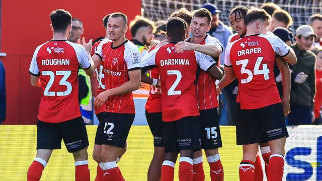 Lincoln celebrate as they take a 1-0 lead against Leyton Orient