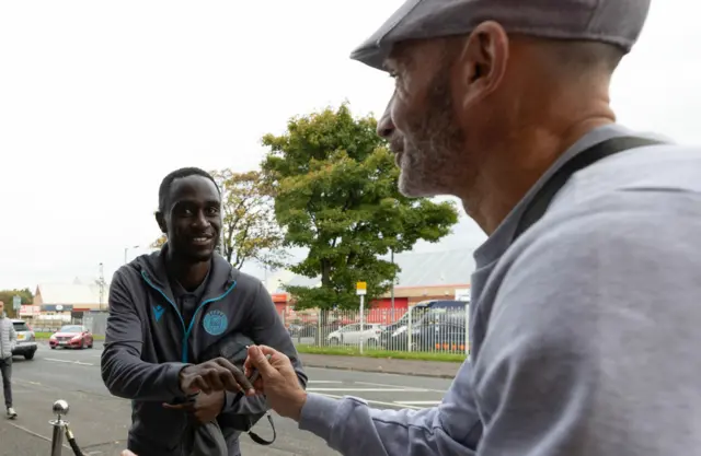 St Mirren's Elvis Bwomono signs an autograph for a supporter