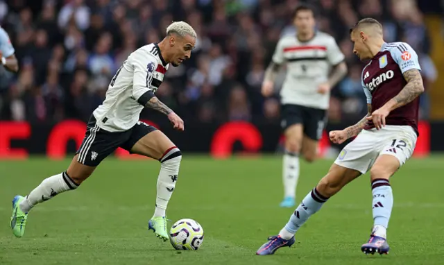 Lucas Dignetries to block a run by Manchester United's Brazilian midfielder Antony