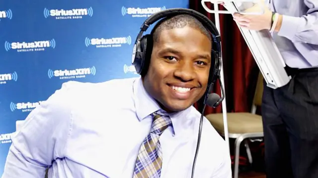 Maurice Jones-Drew smiles while doing radio work