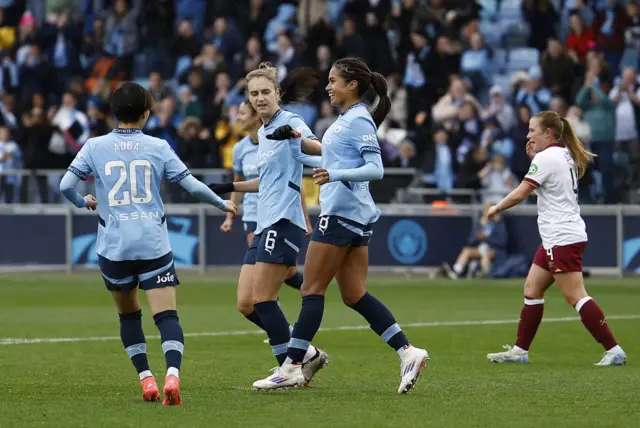 Manchester City's Mary Fowler celebrates scoring their second goal with Manchester City's Vivianne Miedema and Manchester City's Aoba Fujino