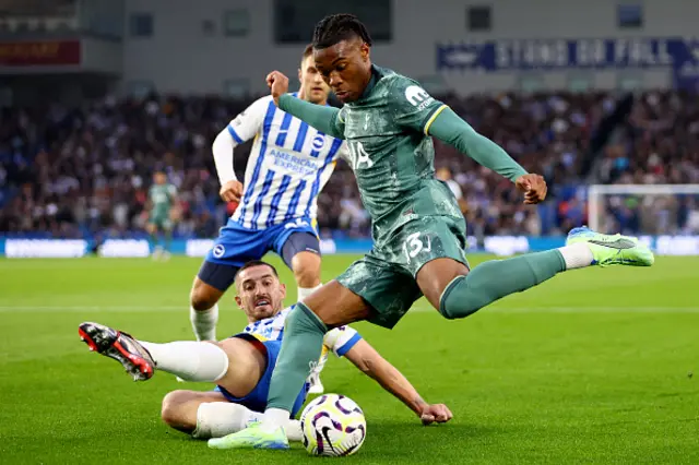 Destiny Udogie of Tottenham Hotspur is challenged by Lewis Dunk