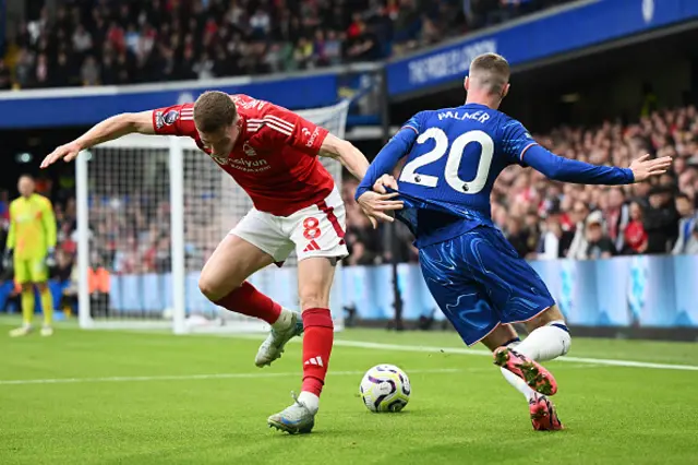 Cole Palmer of Chelsea battles for possession with Elliot Anderson