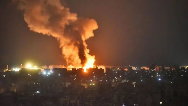 An overnight image showing a fire in Beirut's southern suburbs as smoke billows into the sky