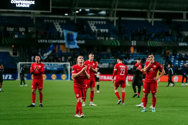 Larne players applaud their travelling fans