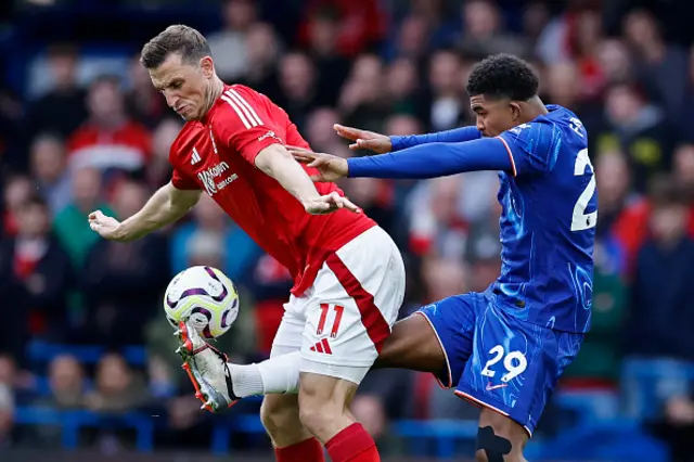 Chris Wood (L) fights for the ball with Chelsea's French defender #29 Wesley Fofana