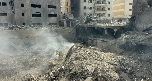 A crater left after an Israeli air strike in Beirut. Rubble is strewn over the ground