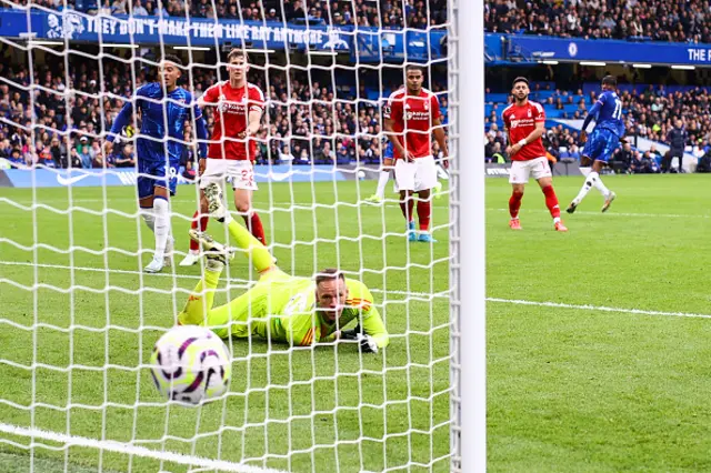 Noni Madueke of Chelsea scores their first goal past Nottingham Forest goalkeeper Matz Sels