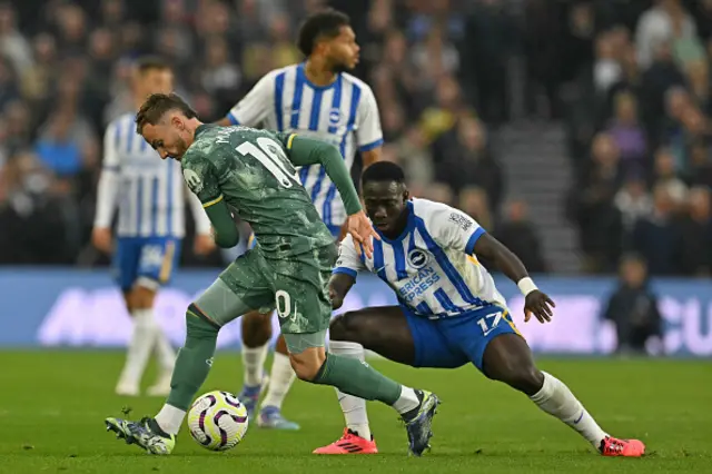 James Maddison (L) vies with Brighton's Gambian midfielder Yankuba Minteh