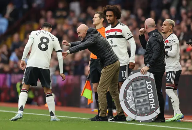 Erik ten Hag Manager / Head Coach of Manchester United talks to Bruno Fernande