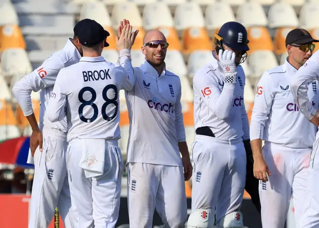 England's Jack Leach celebrates with teammates after taking the wicket of Pakistan's Shan Masood