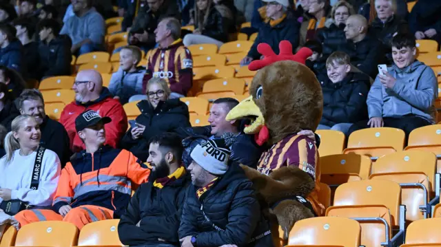 Bradford mascot Billy Bantam watches their win over Newport with fans at Valley Parade