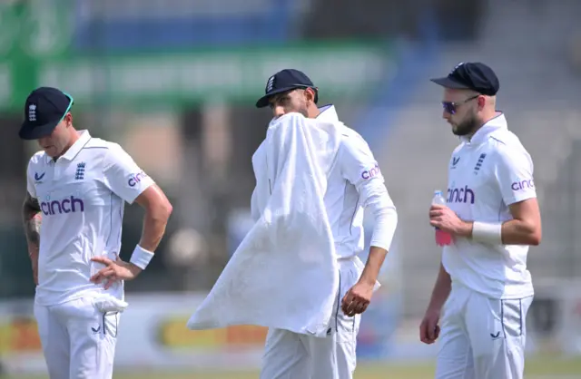 Shoaib Bashir wipes his face with a towel