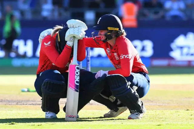 England's Charlie Dean consoles Sarah Glenn after they are knocked out of the Women's T20 World Cup by South Africa in 2023