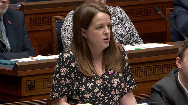 Nuala McAllister wearing her hair down in a black flowery dress