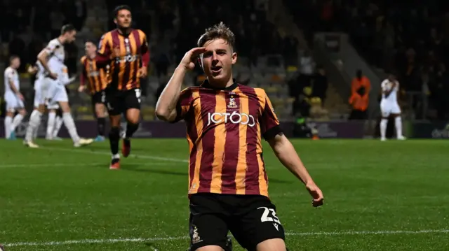 Bobby Pointon salutes after scoring Bradford's third