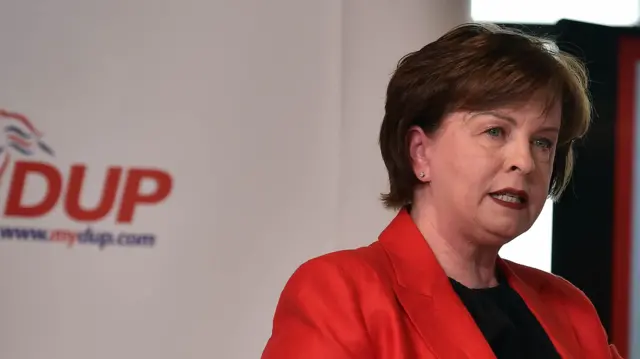 Diane Dodds wearing a red blazer and black top.