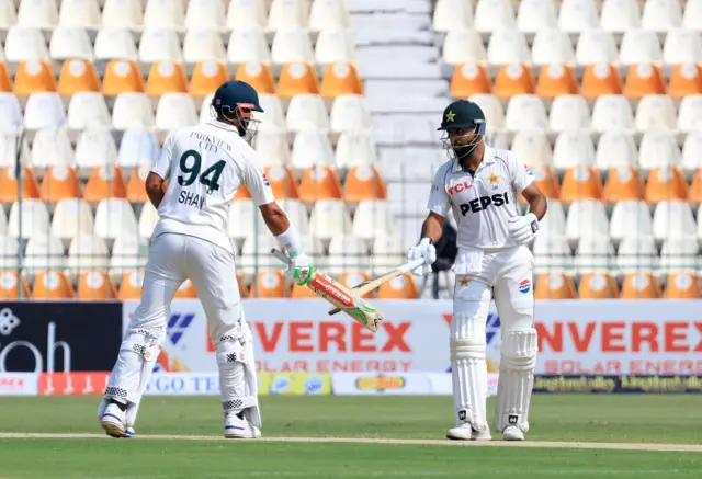 Pakistan's Abdullah Shafique and Shan Masood touch bats