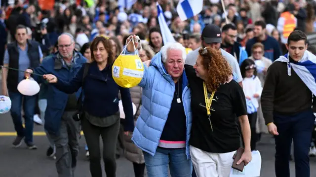 Mourners walking in a Jewish community vigil in Melbourne, Australia