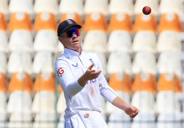 England's Ollie Pope throws the ball