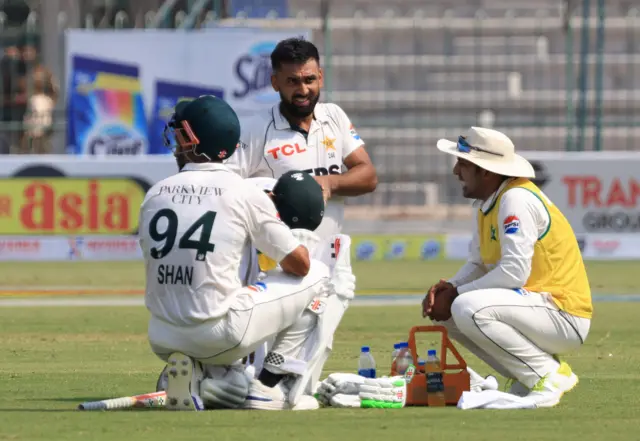 Pakistan's Abdullah Shafique and Shan Masood during a break in play