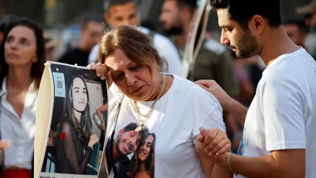 A woman reacts at a gathering to mark one year since partygoers were killed and kidnapped during the deadly October 7 attack by Hamas, at the site of the Nova festival in Re’im