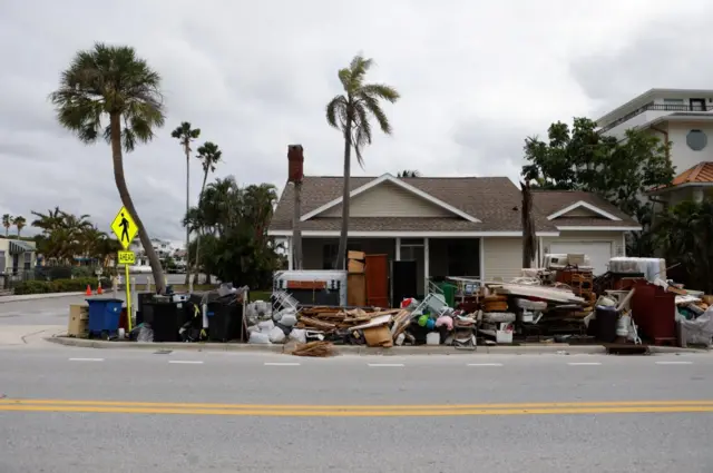 hurricane helene debris amassed outside of florida home