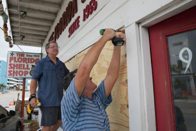 Residents board up stores in Florida before storm