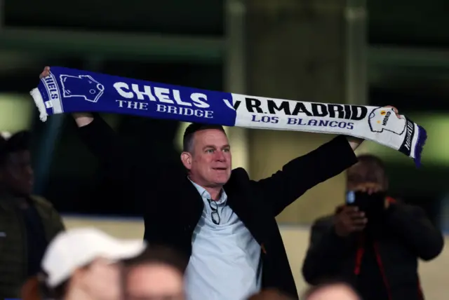 Chelsea fan holding a scarf