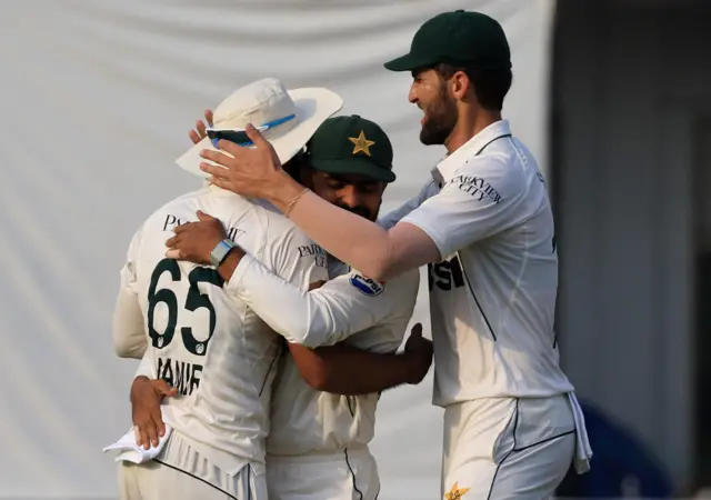 Pakistan's Aamer Jamal celebrates with teammates after taking a catch to dismiss England's Ollie Pope off the bowling of Naseem Shah