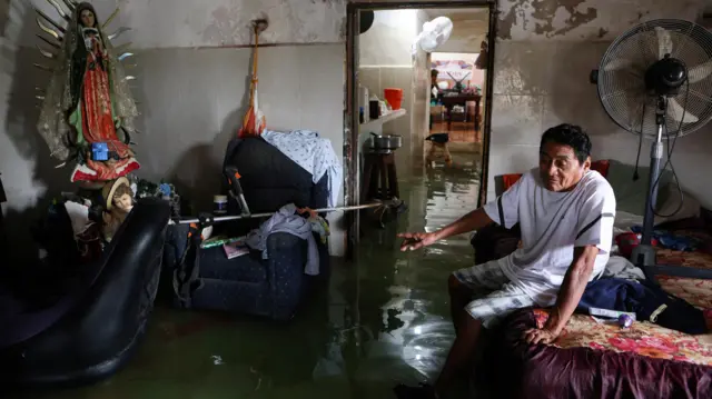 Aurelio Ortiz sits in his flooded home after Hurricane Milton brought heavy rain to Mexico's Yucatan Peninsula on its way to Florida, in Celestun, Mexico October 8, 2024. REUTERS/